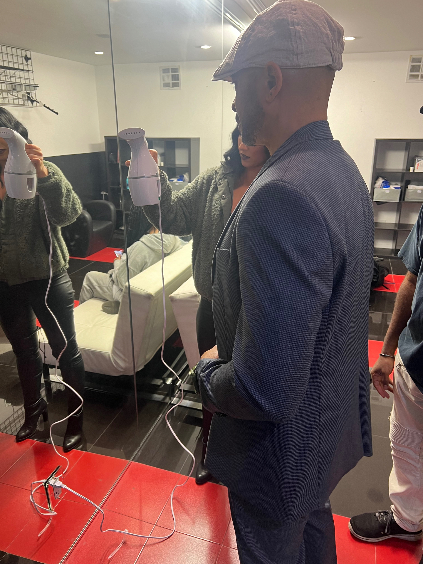A Dogbelly cast member receiving styling in a mirrored room.